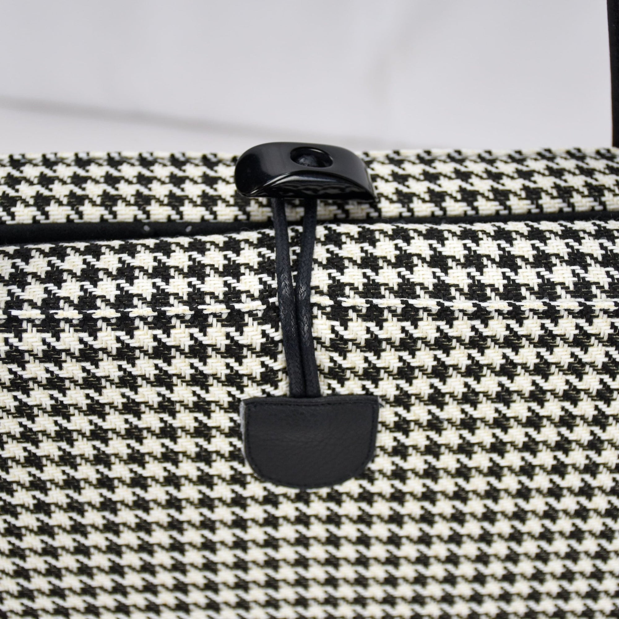 KONA CAVE® luxury Travel Dog Bed for restaurants in  Black and White Houndstooth with Black Quilted Alcantara faux suede lining.  Keeps pets safe and calm in restaurants and pubs. 
